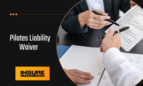 Two professionals in business attire reviewing and signing documents at a table. The text overlay reads "Pilates Liability Waiver" with the Insure Fitness Group logo in the bottom corner.