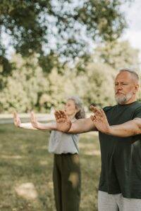 man and woman doing yoga outside