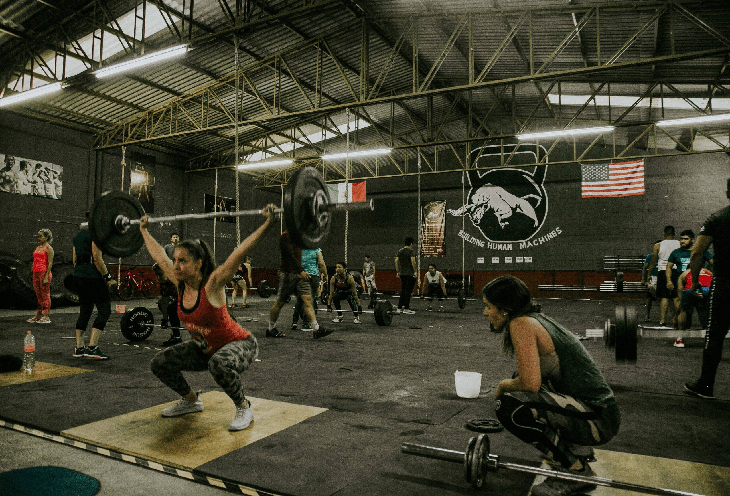 People exercising in a gym, highlighting activities that could require different types of liability insurance for trainers or fitness professionals.
