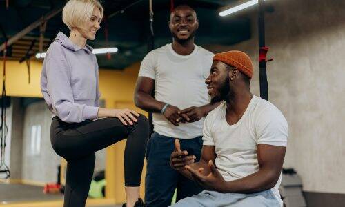 Personal Trainers Talking with one another at the gym.