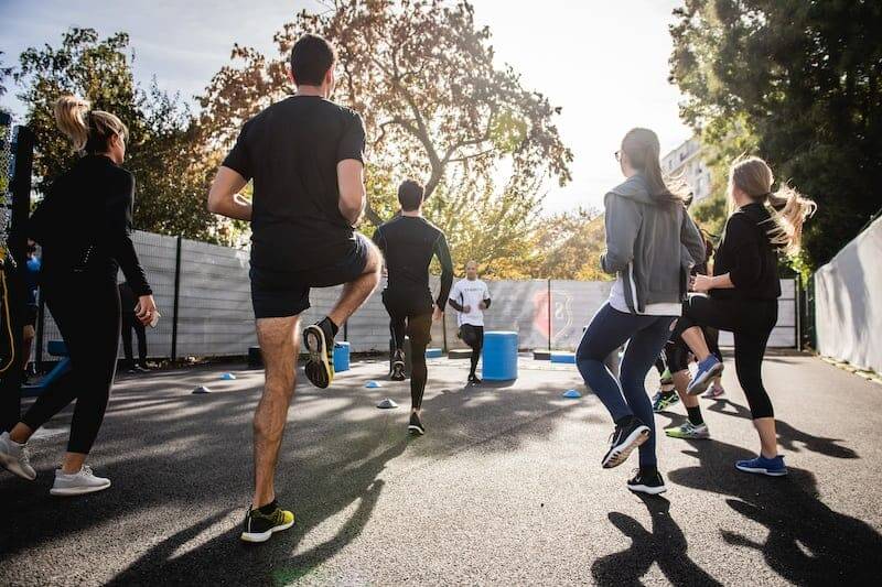 group of people participating in a fitness class that is in progress.