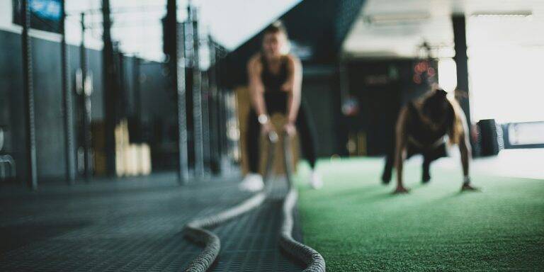 A woman works out with rope exercises.